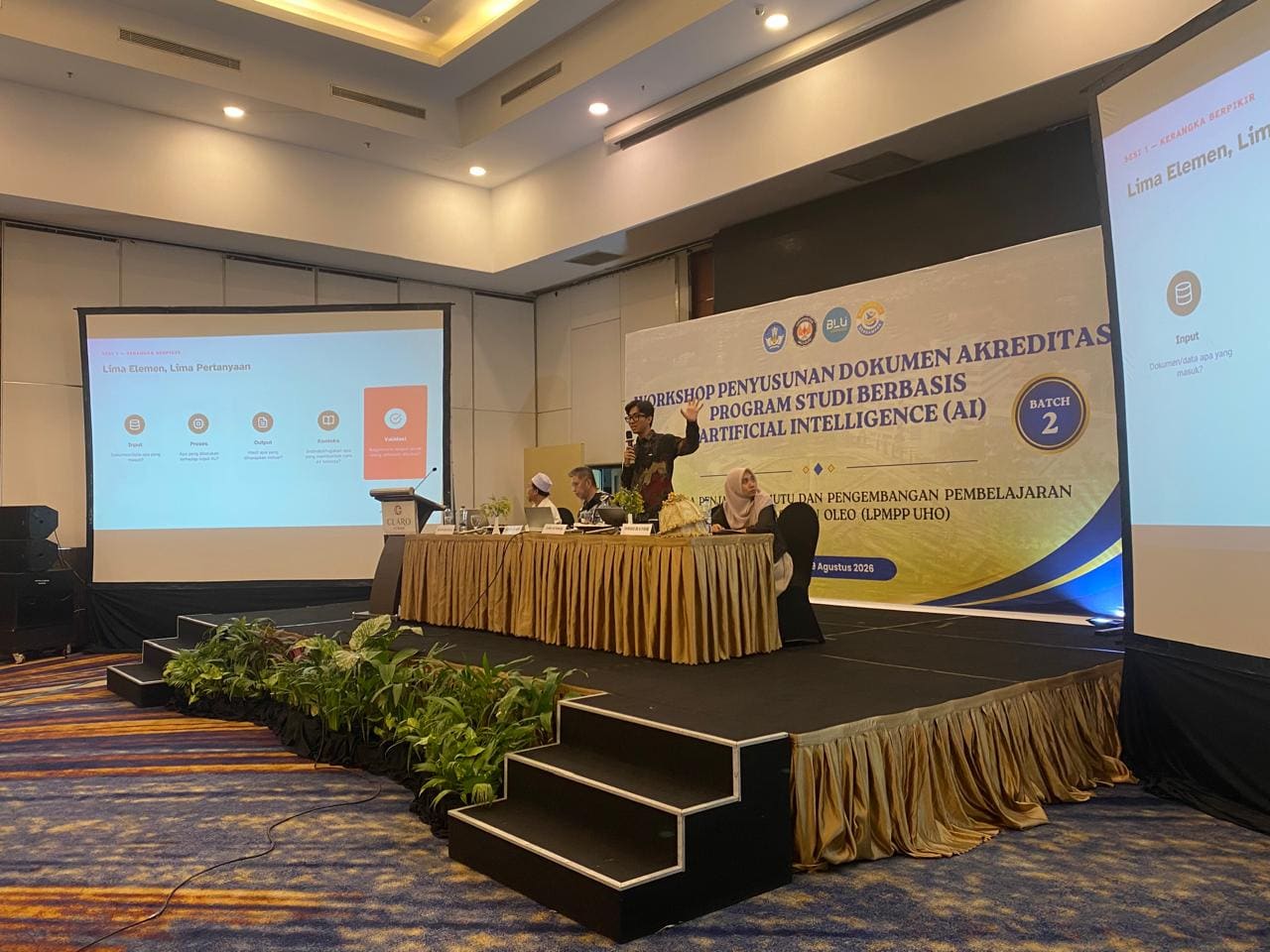 Fahmi Fahreza leading the workshop at Universitas Halu Oleo, in front of the Batch 2 AI-based accreditation document workshop backdrop